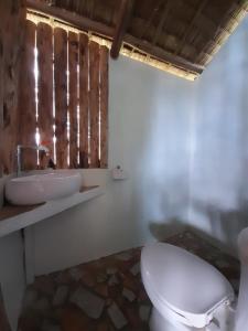 a bathroom with a toilet and a sink at Erlittop Garden Eco Lodge in El Nido