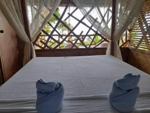 Postel nebo postele na pokoji v ubytování Erlittop Nature Lodge