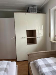 a bedroom with white cabinets and a bed at FeWo-City in Gießen