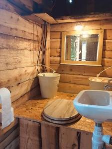 a wooden bathroom with a sink and a mirror at Mongolian yurt sleeping 2+2 with outdoor space in Llanbrynmair