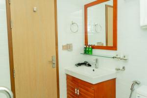 a bathroom with a sink and a mirror at Season Holidays at Hulhumale with Transfer in Hulhumale