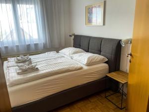 a bed with white sheets and white pillows on it at Apartments Bergblick in Sonnenalpe Nassfeld