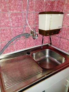 a kitchen sink with a coffee maker above it at Monteur Apartment Victoria in Hagen