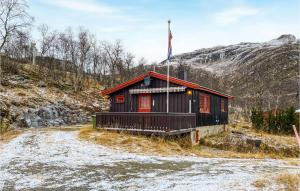 a small house with a flag on top of it at 3 Bedroom Lovely Home In Tyinkrysset in Tyinkrysset