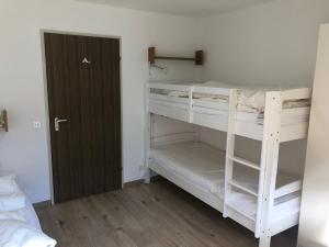 a room with two bunk beds and a door at Breiten 1 in Mörel