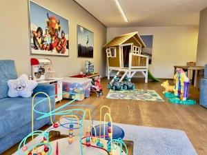 a living room filled with toys and a blue couch at Apartment Pale in Fiss