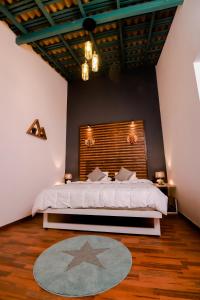 a bedroom with a large bed with a wooden headboard at Stairway way to Heaven in Ambalangoda