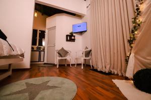 a living room with two chairs and a television at Stairway way to Heaven in Ambalangoda