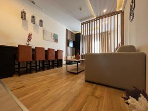 a salon with a waiting room with a couch and chairs at Milmari Apartments FREE SPA & PARKING Kopaonik in Kopaonik