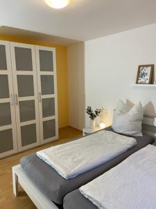 a bedroom with two beds and a cabinet at Ferienwohnung Vater Rhein Mittelrheintal in Sankt Goar