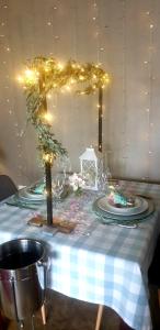 a table with a blue and white table cloth with lights at The Darling Farmstyle B&B in Krugersdorp +26 photos