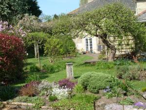 a garden in front of a house with flowers at Elloe Lodge in Holbeach