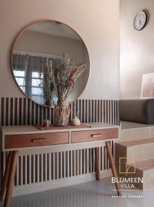 a dressing table with a mirror in a room at Blumeen Villa 2 in Kuala Terengganu