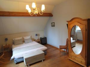 Hostellerie au Coeur du Spinois tesisinde bir odada yatak veya yataklar