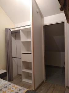 a closet in a bedroom with a door open at Studio de charme à la campagne in Clayes