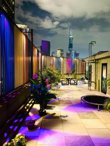 a rooftop patio with purple lights on a building at ESSY Hotel KL Sentral in Kuala Lumpur