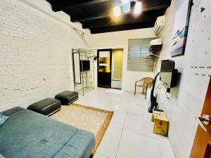 a bedroom with a bed and a brick wall at Yilan Night Market Whole House in Yilan City