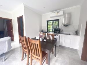 a kitchen with a dining room table and chairs at Entire new granny flat with 3 bedrooms 2 bathrooms in Sydney