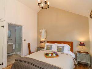 a bedroom with a bed with a basket on it at The Bothy at Snape Hall in Snape