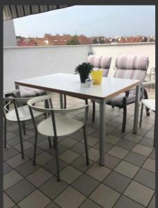 a table and chairs on a balcony with a view at Lilia apartment in Zagreb