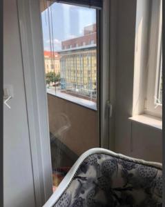 a chair sitting in front of a window at Lilia apartment in Zagreb