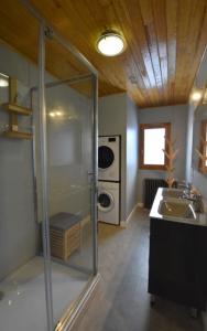 a bathroom with a glass shower and a sink at Chalet de montagne in Formiguères