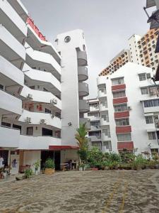 two tall white buildings next to each other at Fuji Home in Bayan Lepas