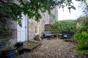 a garden with chairs and a white door at 18th Century Manor with Sauna 