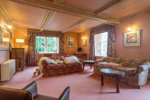 a living room with a couch and a table at 18th Century Manor with Sauna 