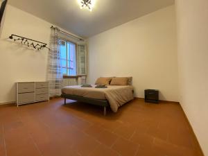 een slaapkamer met een bed en een groot raam bij Les Tres Chic in Cesena