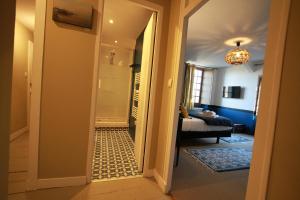 a hallway leading to a living room with a bathroom at La Haute Flourie - bed and breakfast -chambres d'hôtes in Saint Malo