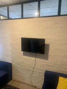 a flat screen tv hanging on a wall at Located in the heart of the city in Johannesburg