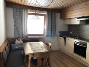 a small kitchen with a table and a couch at Ferienhaus Gerti Werfenweng in Werfenweng