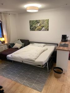 a bedroom with a bed and a table and a counter at 2-Zimmer Ferienwohnung "Am Waldrand" in Schönwald