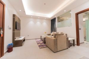 a living room with a couch and a table at Riyadha Home Apartment in Riyadh