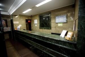 a long counter in a building with a sign on it at Hotel Columbia in Sao Paulo
