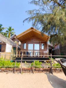 a house on the beach with a fence at Fisherman Cove Agonda in Canacona