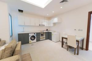 a kitchen and dining room with a table and a microwave at Riyadha Home Apartment Economy in Riyadh