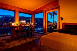 a bedroom with a dining room table with a view of the city at Panorama Apartment Bauernhof Mandl in Murau