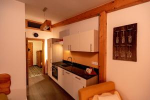 a kitchen with white cabinets and a counter top at Panorama Apartment Bauernhof Mandl in Murau