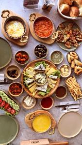 a table full of different types of food on plates at Gloria Suite Hotel in Trabzon