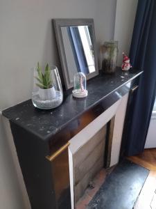 a black and white console table with a mirror at Chambre - Marceau in Courbevoie