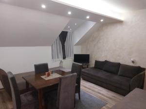 a living room with a couch and a table at Apartments Vila Djurdja in Kopaonik