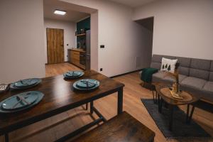 a living room with a table and a couch at Apartmány U Rodinky in Lipova Lazne