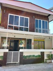 a building with a sign in front of it at Baan Chiang Maan in Chiang Mai