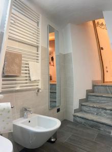 a bathroom with a white sink and a staircase at C'era una Volta in Valtournenche