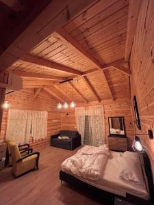 a bedroom with a bed and a chair in a room at צימר נור החרמון in Majdal Shams
