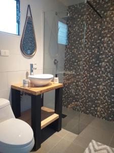 a bathroom with a sink and a shower at Peumayenlodge Cabaña moderna in Antuco +18 photos