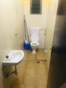 y baño con aseo y lavamanos. en Hyven's Apartments en Mtwapa