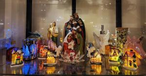 a display of christmas figurines on a glass table at Lucky East Serin with Netflix DisneyPlus FreeCoffeeTea & Recliner in Tagaytay